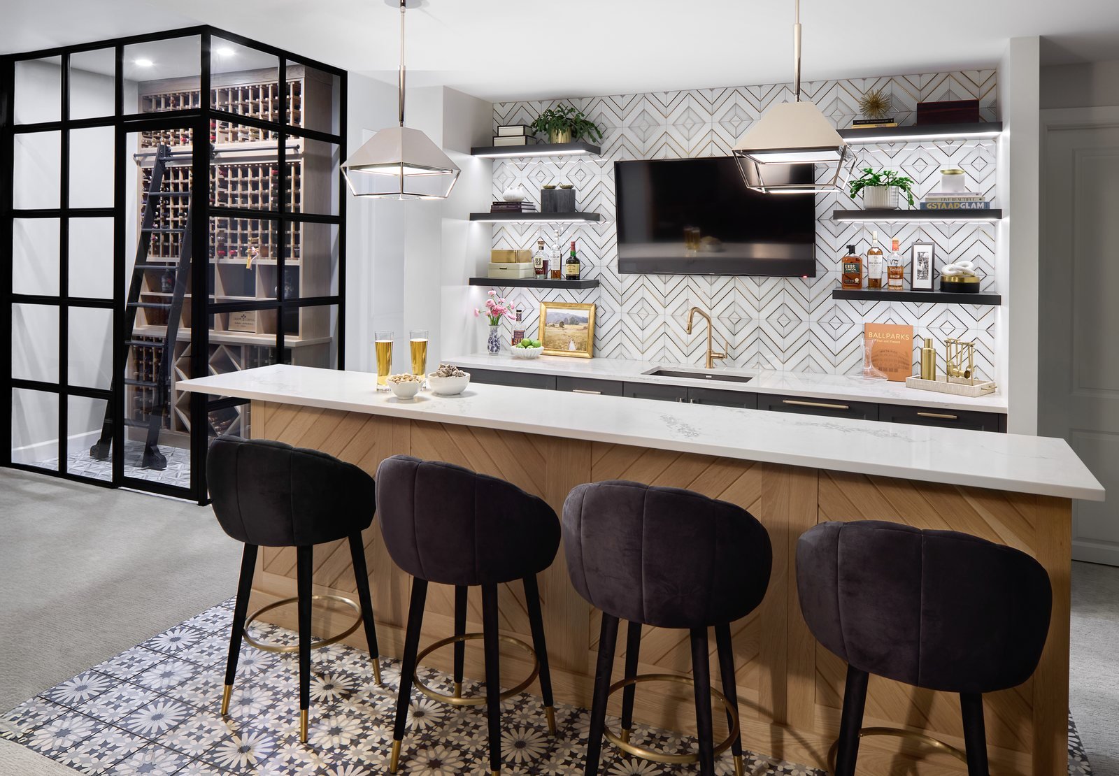 Basement bar with velvet stools, geometric tile backsplash and a steel-framed glass wine room in the Bonnie Brae remodel, Denver.