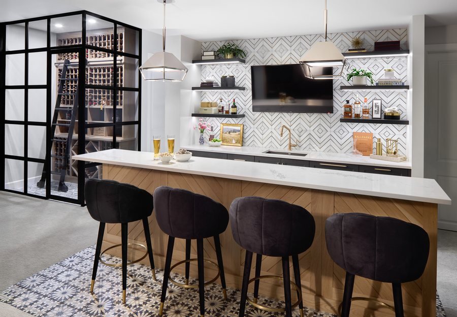 Basement bar with velvet stools, geometric tile backsplash and a steel-framed glass wine room in the Bonnie Brae remodel, Denver.