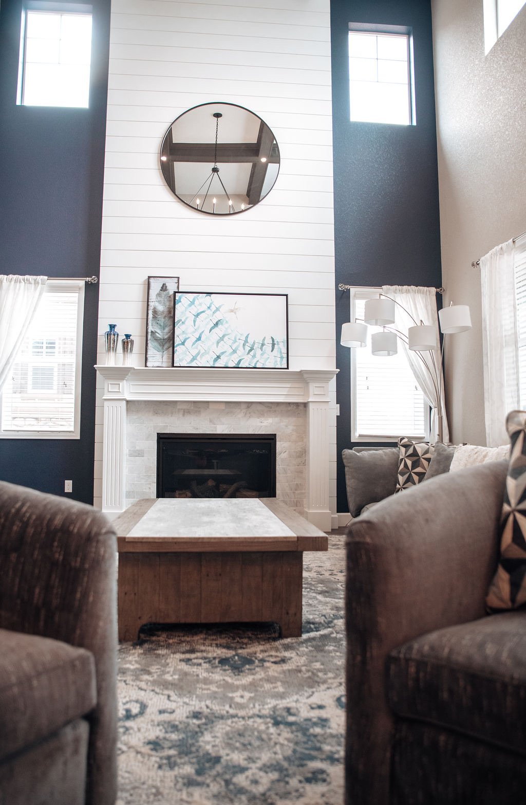 Mantle styling with vases and coastal art, Blackstone family room renovation in Aurora, Colorado
