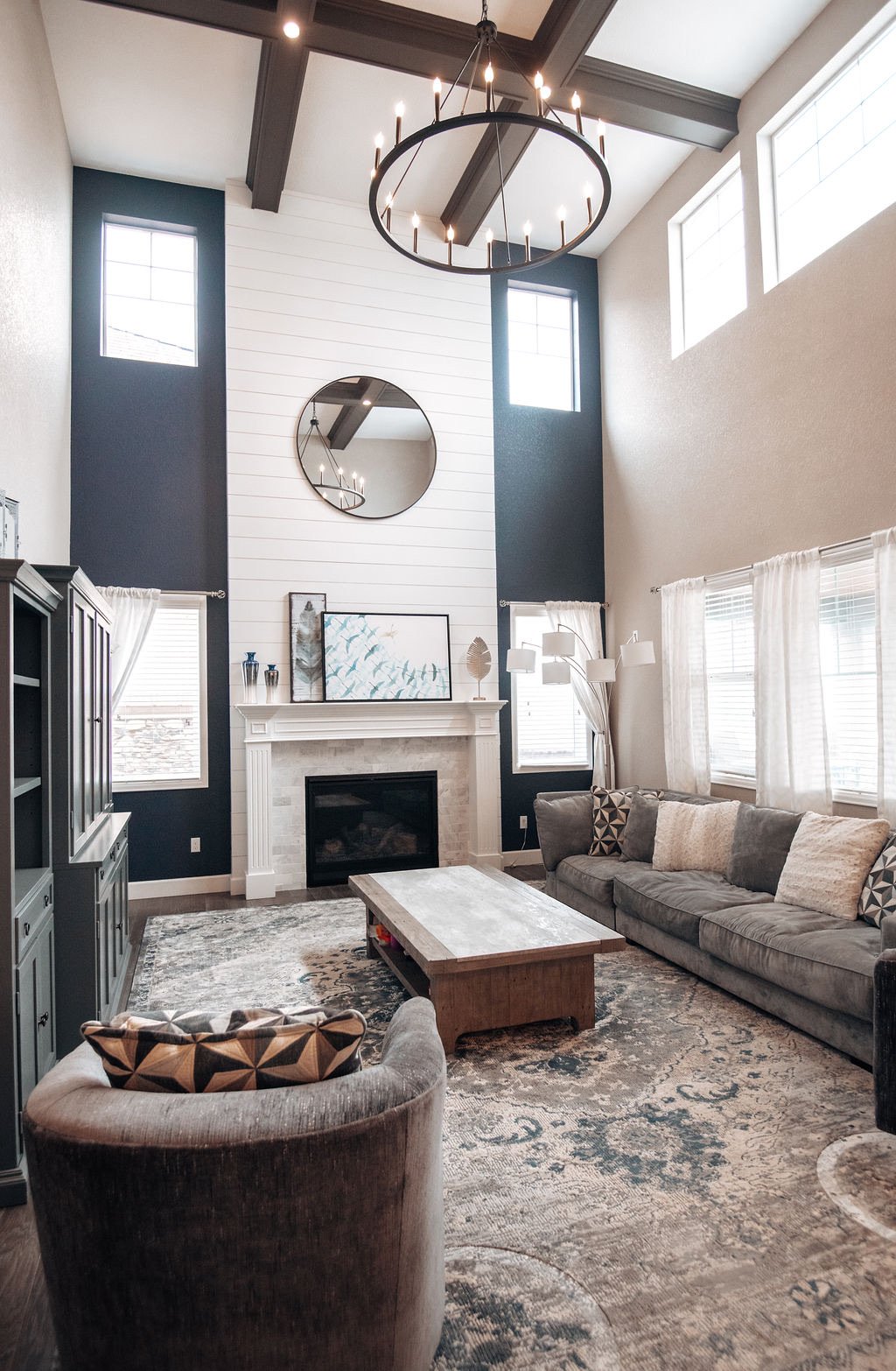 Family room with navy accent walls and layered blue rug, Blackstone family room renovation in Aurora, Colorado