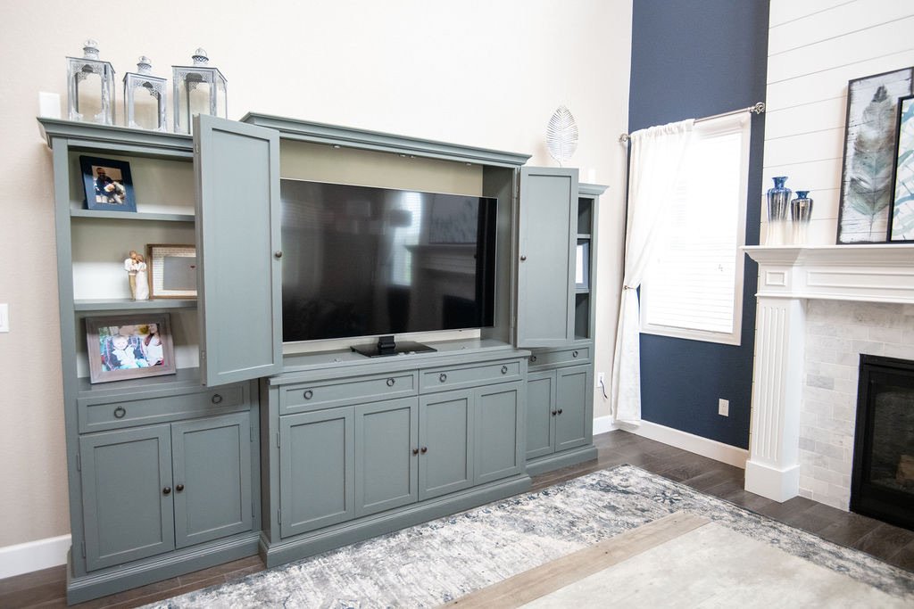 Entertainment center open to reveal the television, Blackstone family room renovation in Aurora, Colorado