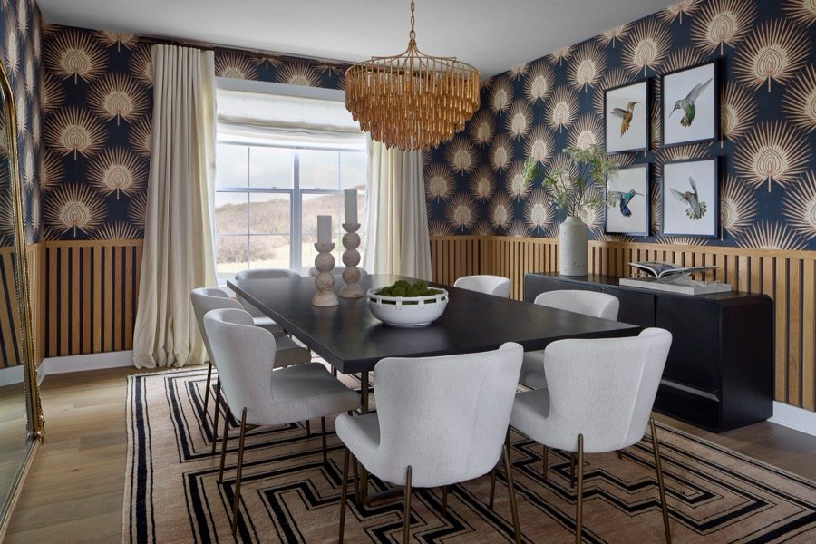Entry with teal paneled wall, round mirror, and rust velvet stools in The Canyons at Castle Pines