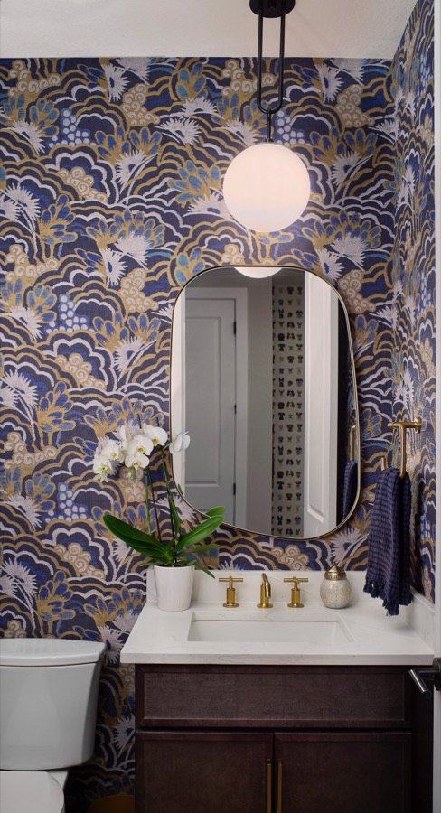 Powder bathroom with blue and gold patterned wallpaper and brass fixtures, The Canyons at Castle Pines